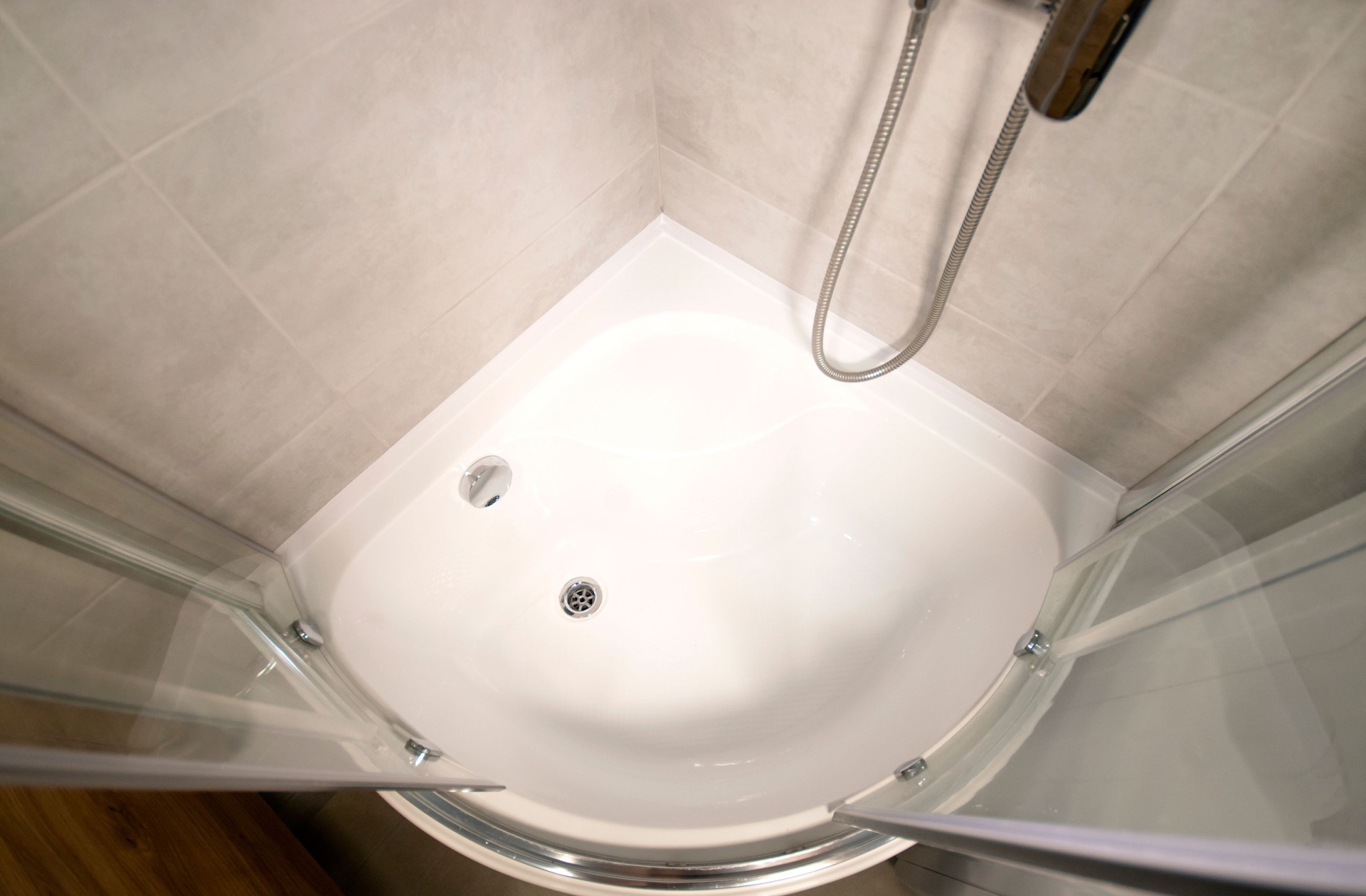 A shower cabin with a deep acrylic tray. View above.